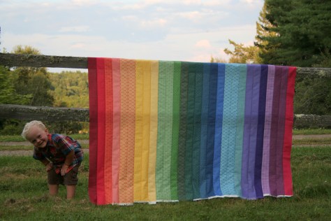 helpful kids and a rainbow jellyroll quilt