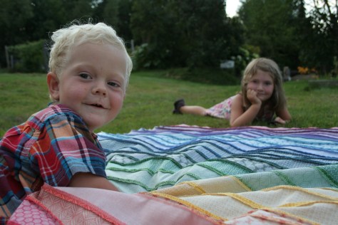 helpful kids and a rainbow jellyroll quilt