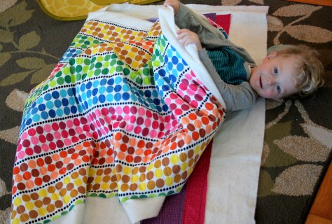 my little helper in the rainbow jellyroll quilt