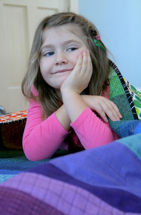 maddie on her rainbow quilt