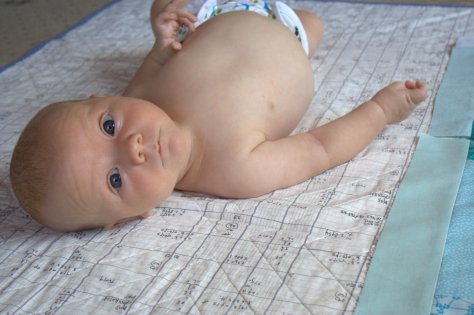 Finn 3 months old quilt looking around